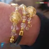 Bracciale Redentore regolabile variante oro e nero indossato
